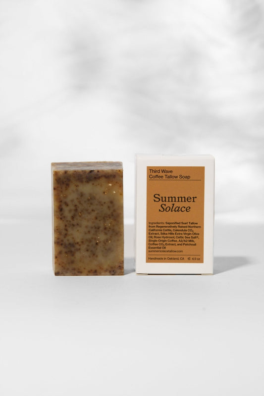 Dark brown speckled bar soap with box labeled Summer Solace